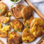 Crispy Air Fryer Smashed Potatoes served with herbs and dipping sauces.