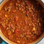 Delicious homemade Bolognese sauce simmering in a pot with fresh ingredients.