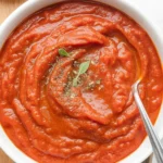 Easy homemade pizza sauce recipe made with tomatoes, garlic, and olive oil.