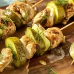 Dill Pickle Chicken Skewers grilled and served with ranch dressing.