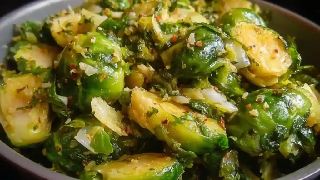 A serving of Garlic Butter Brussels Sprouts topped with fresh herbs