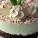 No-bake peppermint cheesecake topped with chocolate shavings and mint leaves