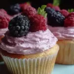 Vanilla cupcakes decorated with colorful berry frosting