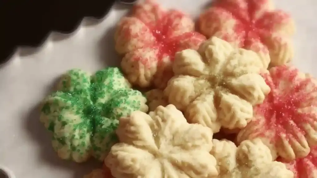 Batch of easy Christmas spritz cookies on a festive plate