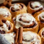 Freshly baked gingerbread cinnamon rolls with icing on top
