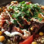 Quinoa Beef Bowl with Tahini Dressing garnished with fresh ingredients