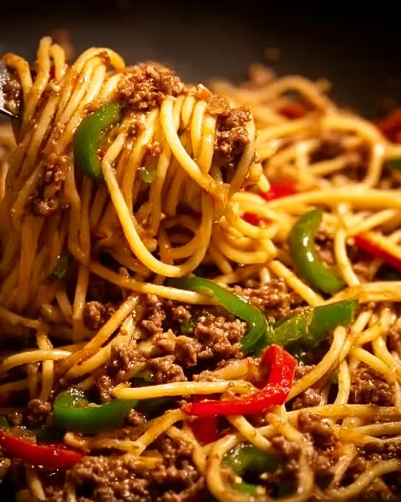 Dish of Chinese Style Ground Beef Pasta with vegetables and herbs.