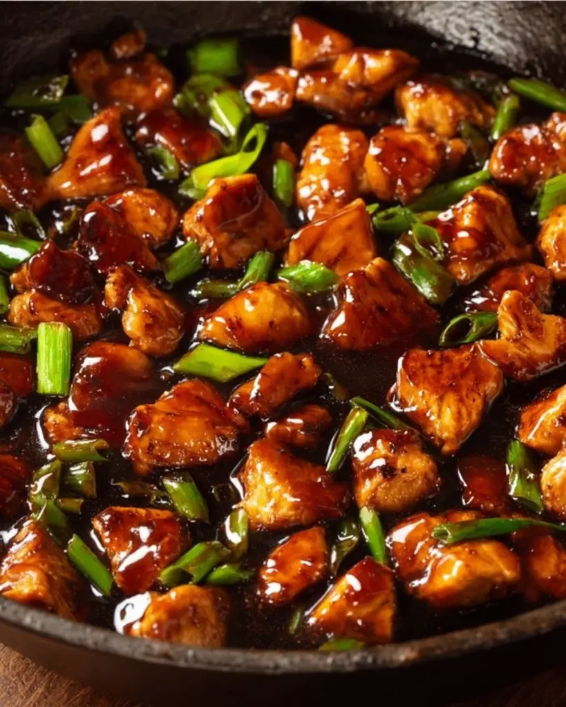 Delicious plate of Mongolian Chicken garnished with green onions.