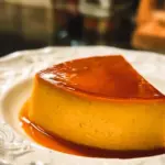 Delicious homemade flan served on a plate with caramel sauce.