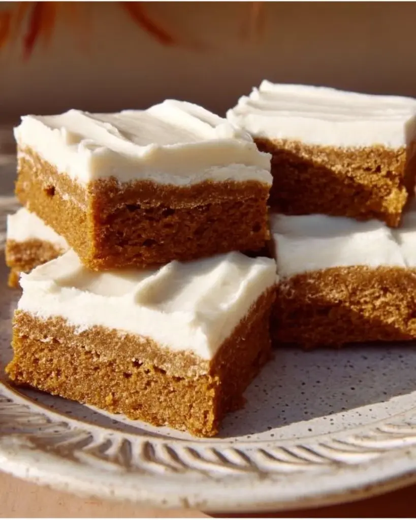 Delicious chewy gingerbread bars topped with icing and spices