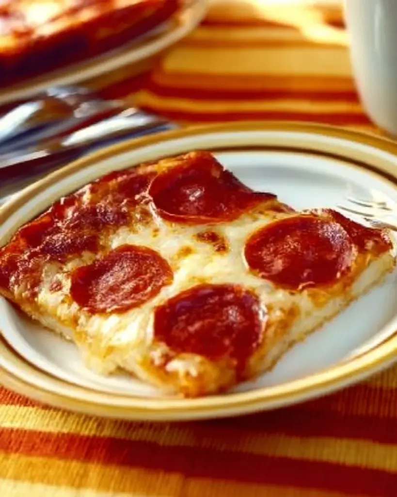 Low Carb Pizza Casserole topped with cheese and pepperoni in a baking dish