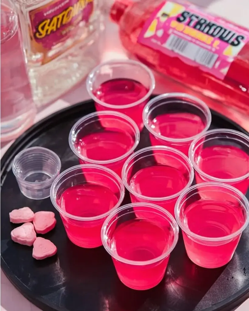 Pink Starburst Jello Shots served in colorful cups for a festive party drink