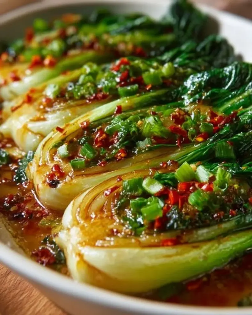 Quickly prepared Bok Choy with Ginger Chili Sauce garnished and served in a bowl.