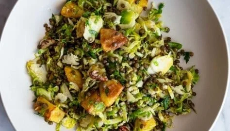 Warm Brussels sprout salad with crispy toppings and a savory dressing
